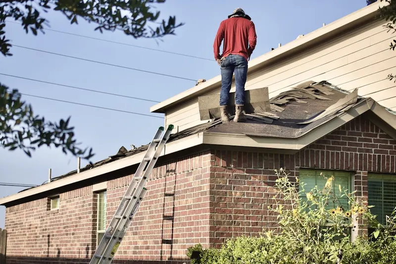 Professional roofer working on a residential roof in Watkinsville